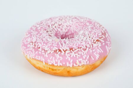 one pink donut with sprinklesの写真素材
