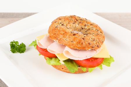 a bagel with sausage and cheeseの写真素材