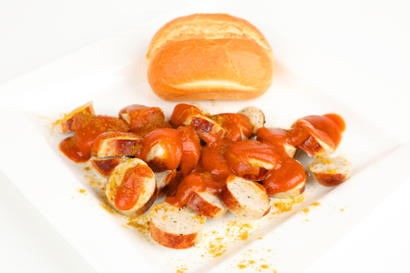 sliced sausage with curry sauce and a rollの写真素材