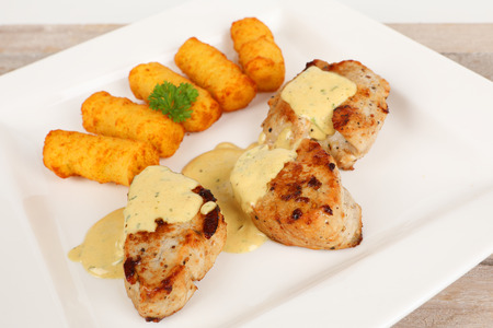 pork fillet with potato croquettes and mustard sauceの写真素材