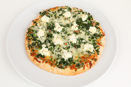 pizza with spinach and ricotta on a plateの写真素材