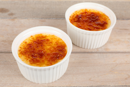Creme brulee in a bowl on a boardの写真素材