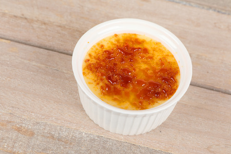Creme brulee in a bowl on a boardの写真素材
