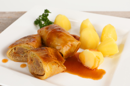cabbage roulade with potatoes on a plateの写真素材