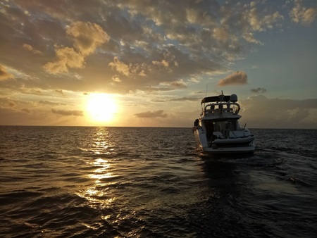 A speedboat on the ocean at sunriseの写真素材