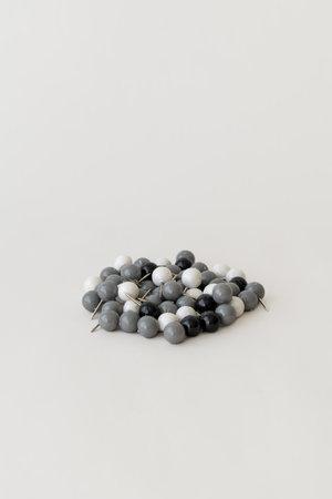 Office supplies concept  push pins scattered in a small pile on a white background.の写真素材