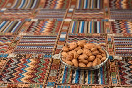 Nuts almonds on a traditional Arabian carpetの写真素材