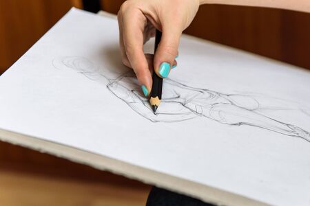 painter paints a pencil sketch on paper