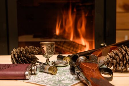 Knife Compass and map lie by the fire. In a fireplace fire burns.の写真素材