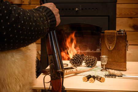 Knife Compass and map lie by the fire. In a fireplace fire burns.の写真素材