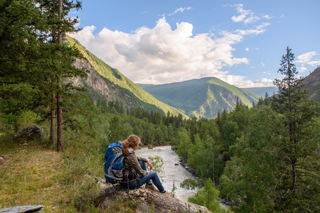 Girl, tourist, on a rock. Below is the deep valley of the river.の写真素材