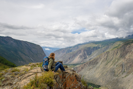 Girl, tourist, on a rock. Below is the deep valley of the river.の写真素材