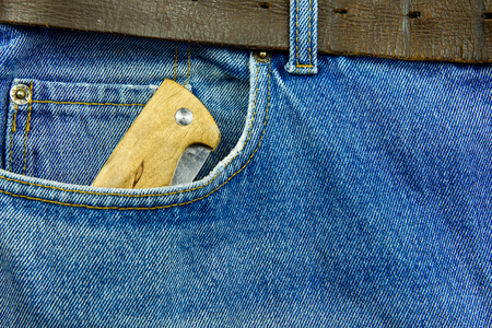 Wooden handle sticks out of his jeans pocket.の写真素材