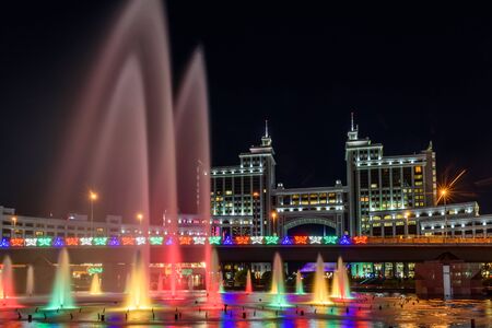 Nur-Sultan, Kazakhstan, August, Fountains with lighting on the background of tall buildings in the center of the capital of Kazakhstan.の写真素材