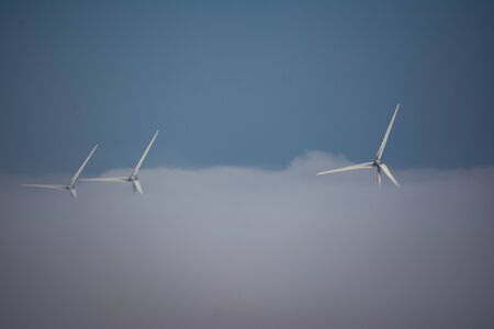 wind turbines engulfed in fogbankの写真素材