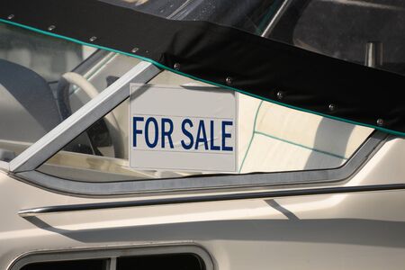 A For Sale sign on a boat in a marinaの写真素材