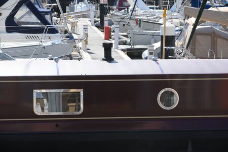 A narrow boat moored on a marinaの写真素材