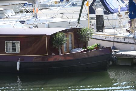 A narrow boat moored to a marina pontoonの写真素材