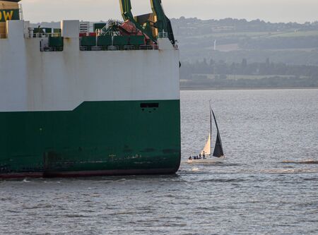 Ship and yacht in near collisionの写真素材