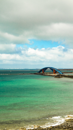 arch bridge over the seaの写真素材