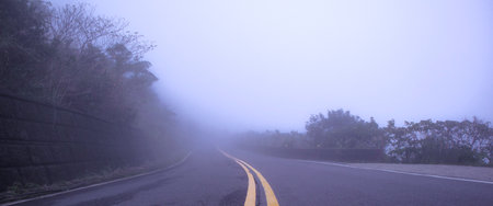 close-up of a foggy road in the mountainの写真素材