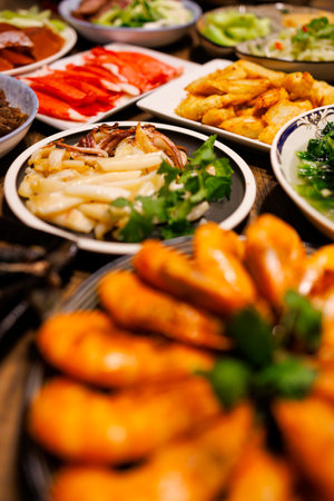 a table full of sumptuous food, including golden grilled squid,の写真素材