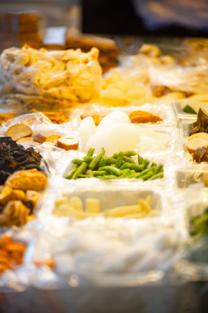 a street vendor's stall displaying a variety of vegetablesの写真素材