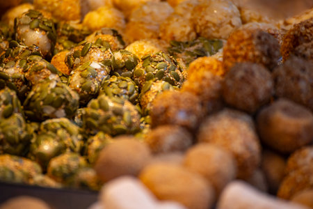 a plate of golden rice candy is piled highの写真素材