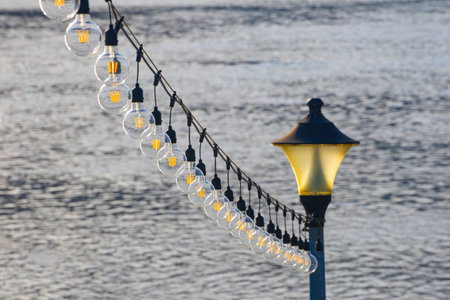 the lights by the harbor emit a warm glow in the nightの写真素材