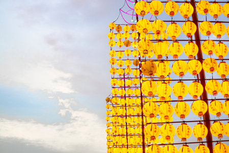 Countless yellow lanterns are densely suspended in the airの写真素材