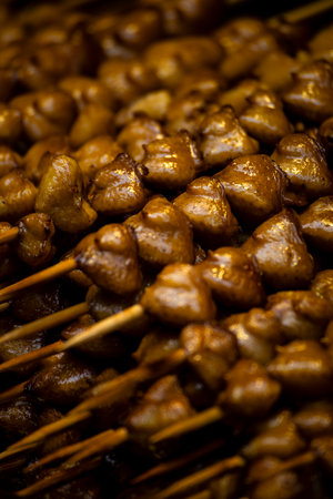 a large pile of grilled chicken butt skewers neatly arranged on a grillの写真素材