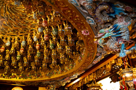 the ornate and complex ceiling structure known as the Caisson Ceiling (ZÇojÇng) in a traditional Asian templeの写真素材