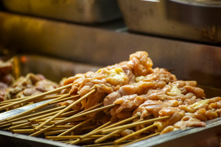 the scene of meat skewers being sold or cooked at a street stallの写真素材
