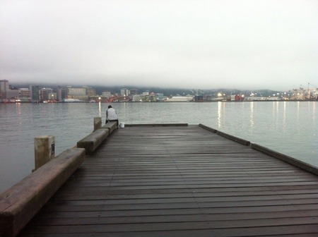 Calm peaceful serene view of city from wharfe early evening as mist rolls inの素材