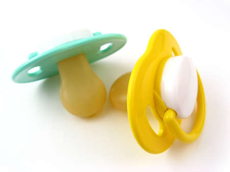 Green and yellow soothers over  white.