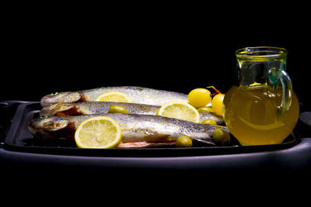 Trouts, olive, olive oil and lemonの写真素材