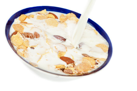 Muesli and milk isolated on white.