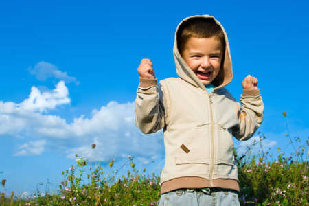 Young boy against blue skyの写真素材