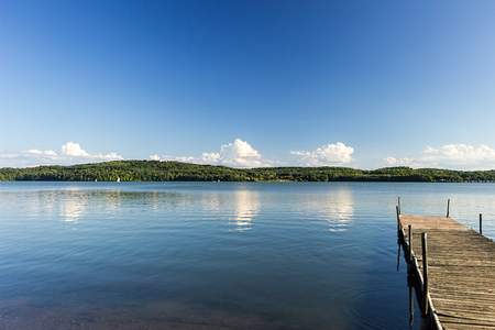 A wooden dock on a lake in summer.の写真素材
