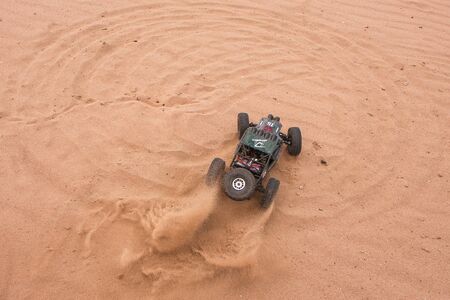 RC car crowler Vaterra Twin Hammers driving through the sandのeditorial素材