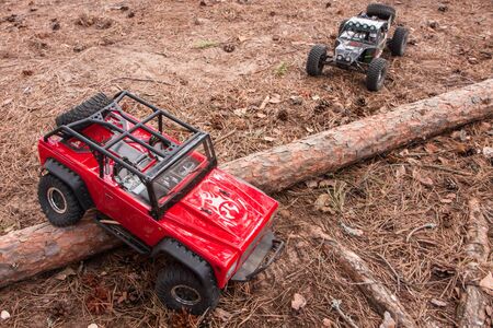 RC cars trophy crowler Jeep and Vaterra Twin Hammers moves over an obstacle from logのeditorial素材