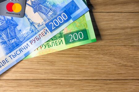 Money and credit card master card on a woody background. Rublesのeditorial素材