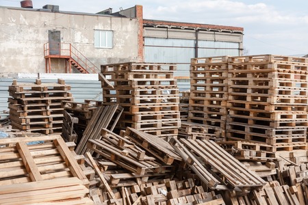 Messy warehouse of old wooden shipping palletの写真素材