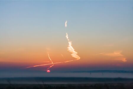 landscape with a mysterious strange unusual cloud in the night sky and creeping purple fogの写真素材