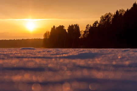 Beautiful winter landscape with the Golden light of the setting sunの写真素材