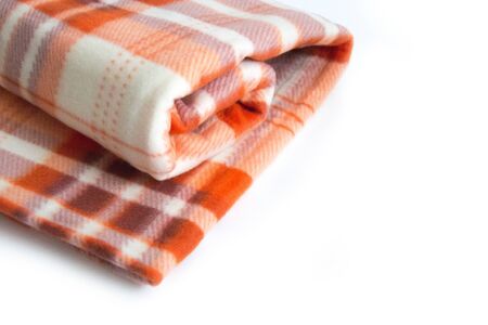 A warm orange fleece plaid with a checkered pattern on a white background.の写真素材