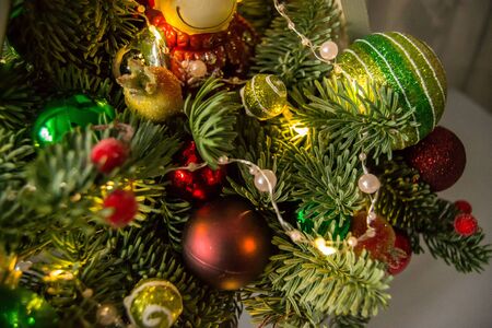 Christmas composition of fir branches with Christmas decorations and garlands.の写真素材