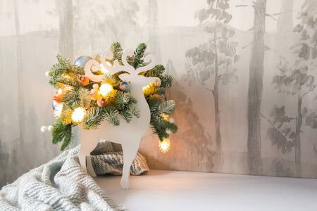 Christmas composition of fir branches with Christmas decorations and garlands on a winter background.の写真素材