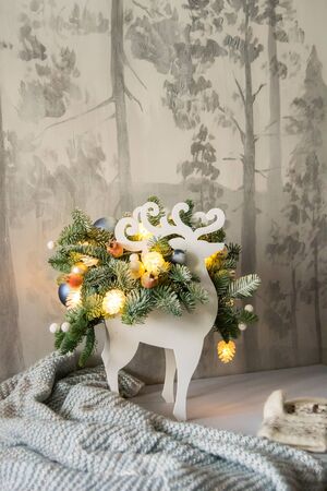 Christmas composition of fir branches with Christmas decorations and garlands on a winter background.の写真素材