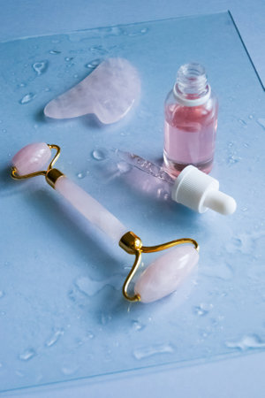 Facial massage attributes: Guasha scraper, cosmetic oil and facial rollerの写真素材